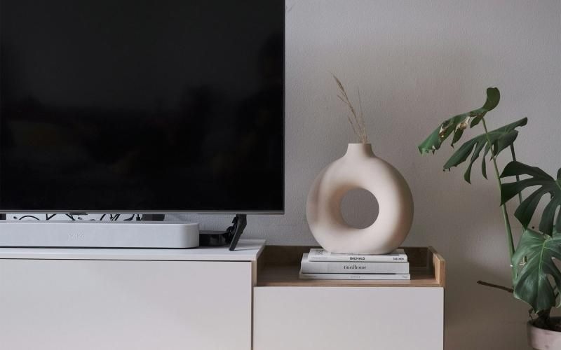 a tv on a stand with decor